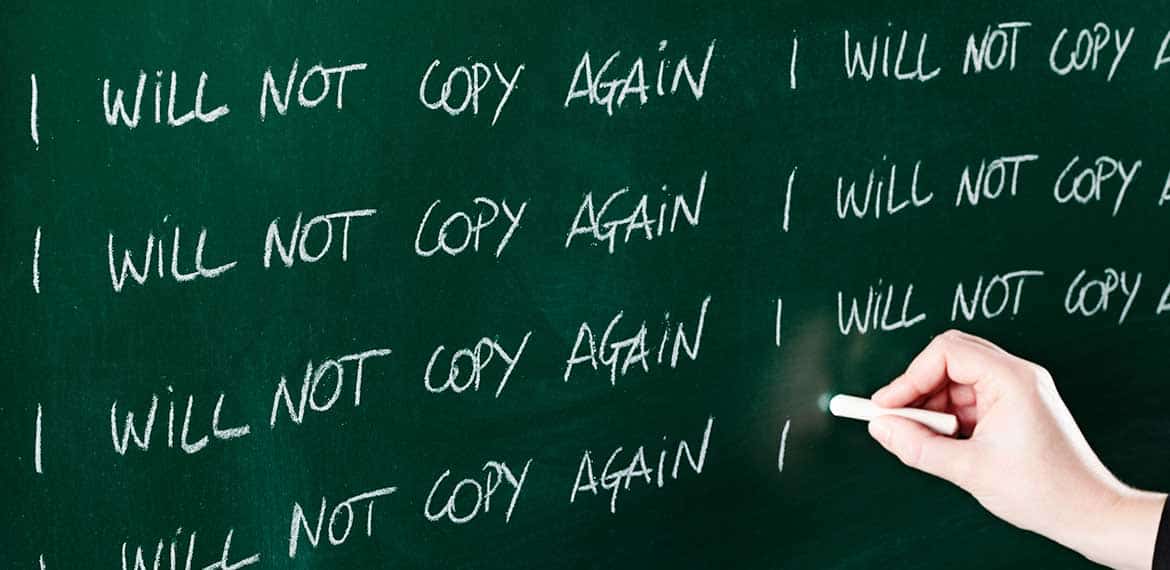 Hand writing 'I will not copy again' repeatedly on a chalkboard, symbolising duplicate content penalties in SEO