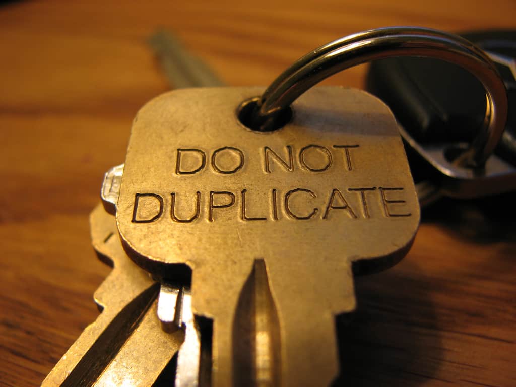 Close-up of a brass key engraved with 'Do Not Duplicate', illustrating the problem of duplicate content in SEO