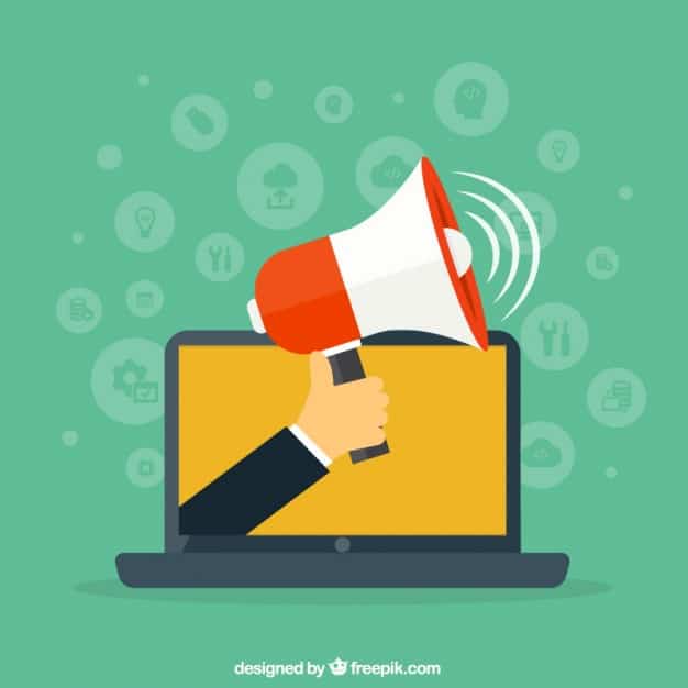 Flat design illustration of a hand holding a megaphone emerging from a laptop, representing online outreach