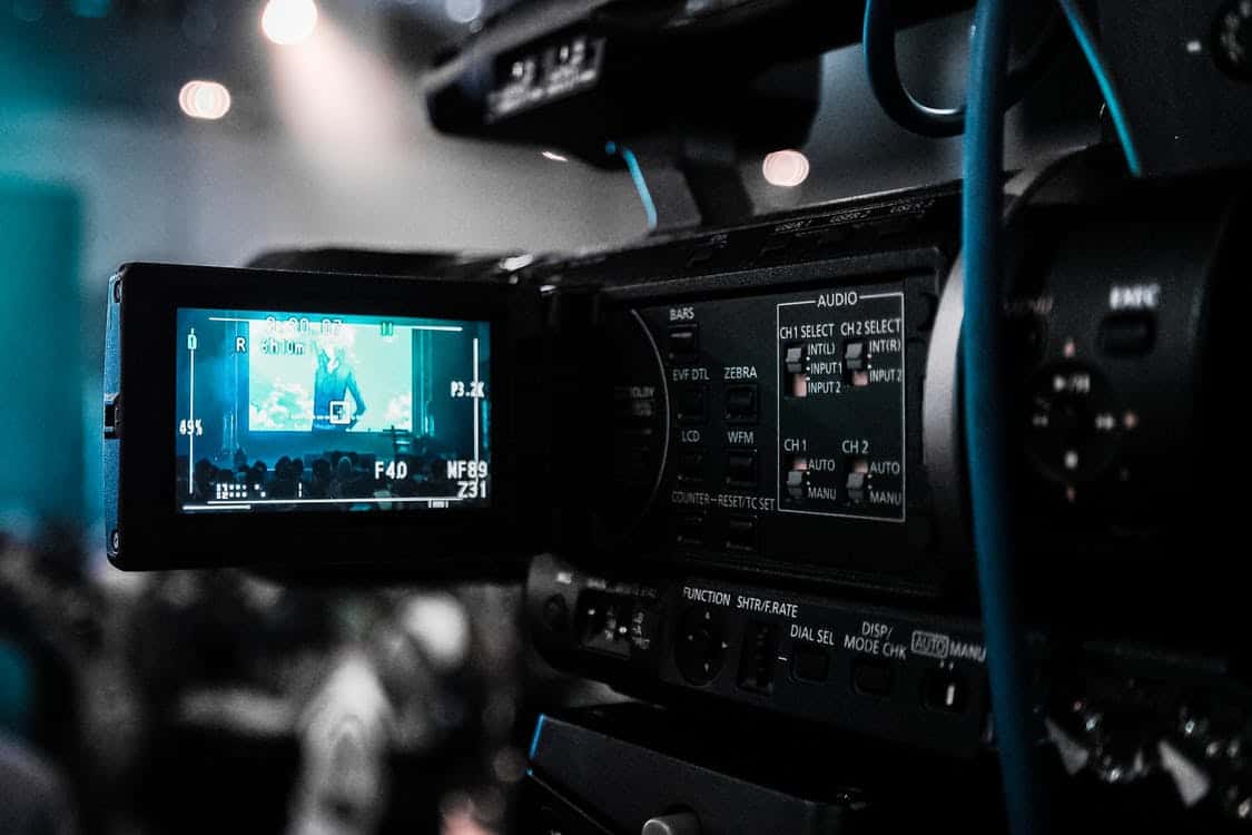 Close-up of a professional video camera monitor recording a live event, illustrating YouTube video production