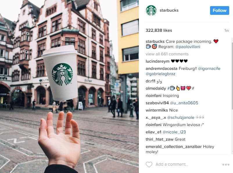 Starbucks Instagram post showing a cup appearing to float above an outstretched hand in a European city square