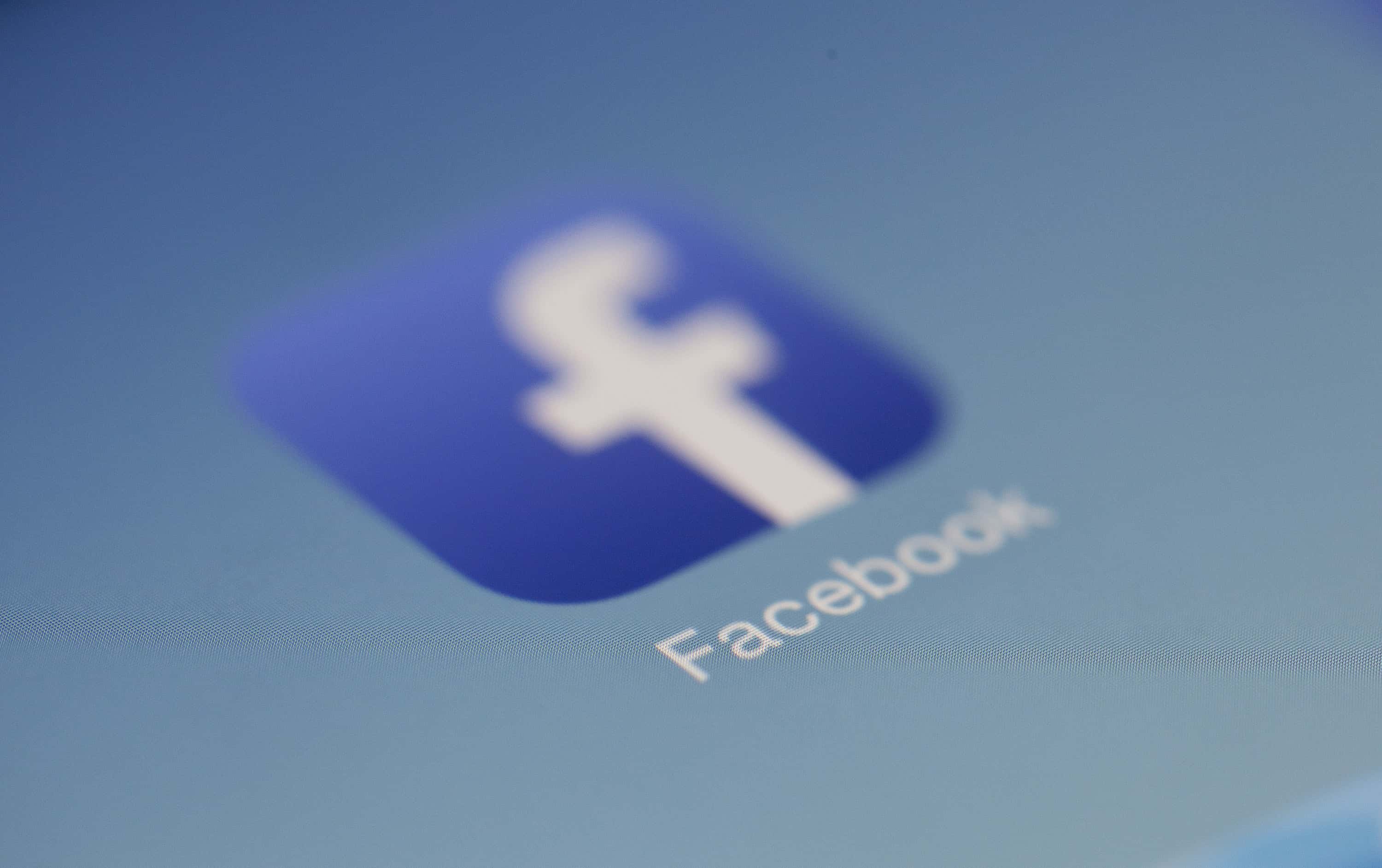 Close-up of the Facebook app icon on a tablet screen, illustrating AMP on social platforms