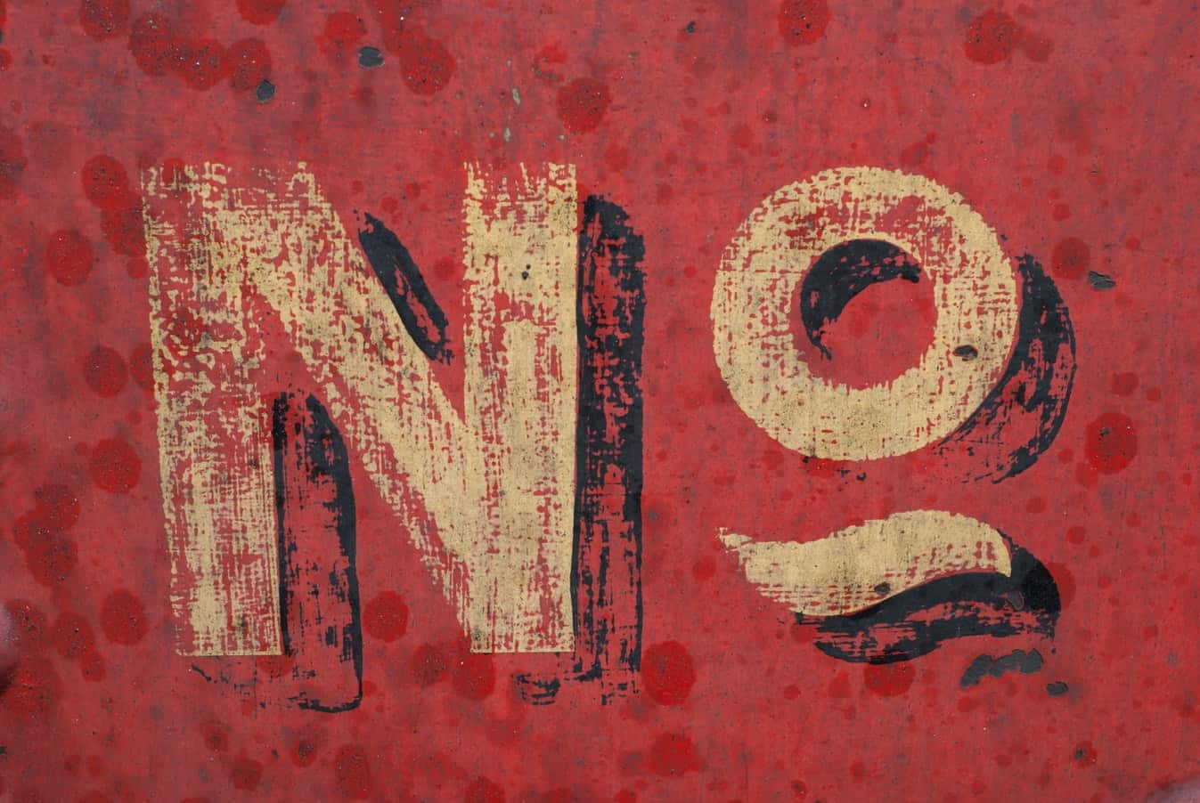 Weathered red metal surface with stencilled No symbol, illustrating time management limits