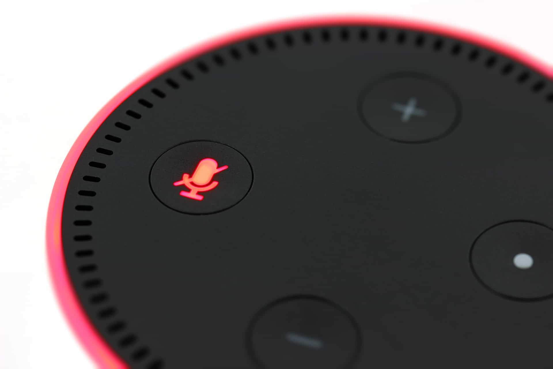 Amazon Echo Dot smart speaker with microphone mute button glowing red, representing voice search technology