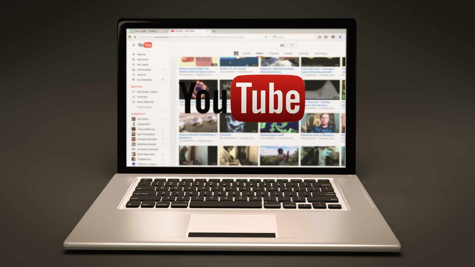 YouTube homepage displayed on a laptop screen with the YouTube logo overlaid, illustrating YouTube SEO ranking factors