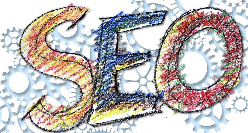 Colourful crayon-style letters spelling SEO against a background of grey gear wheels