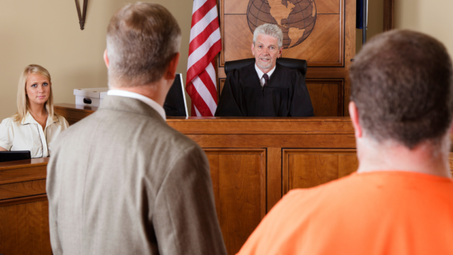 Judge presiding over courtroom scene with lawyers and defendant, representing digital marketing for criminal lawyers