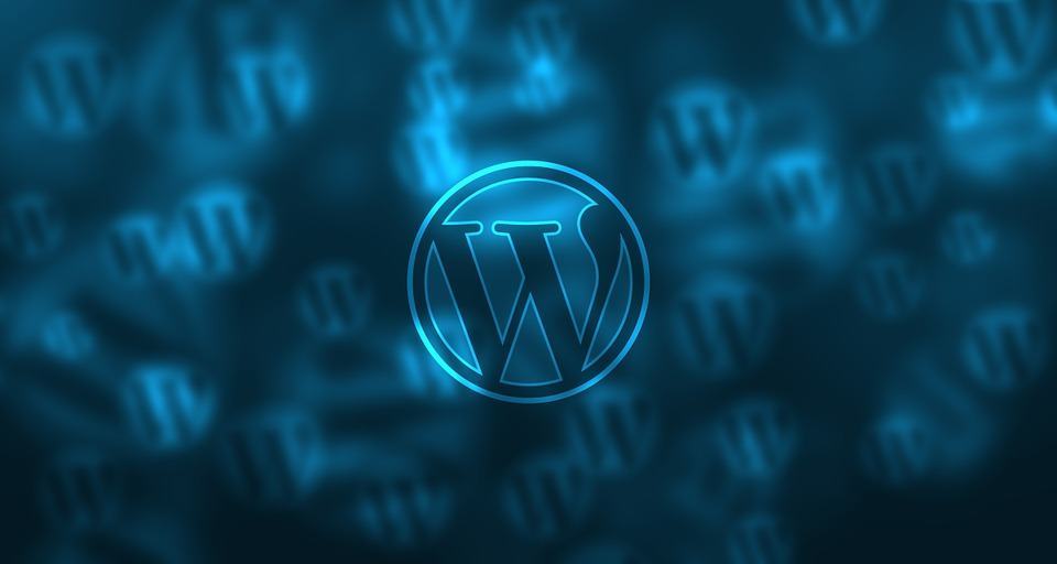 WordPress logo glowing in blue neon light against a dark background with repeated W symbols